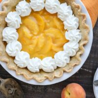 This Fresh Peach Pie has a no-bake filling that uses fresh, uncooked peaches and a simple homemade glaze inside of a crisp pie crust. A great recipe for fresh peaches!