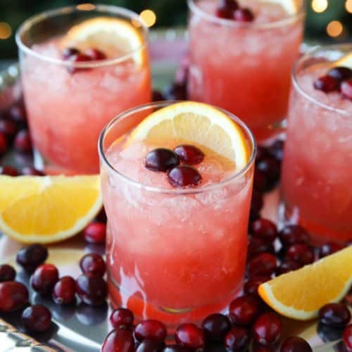 This non-alcoholic Cranberry Orange Mocktail is an easy and refreshing fruit punch drink for the holidays. It's fizzy, fruity, and only 3 ingredients!