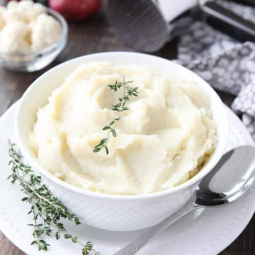 Lightened-up Creamy Cauliflower and Mashed Potatoes is a healthier side dish, with half cauliflower and half potatoes. Velvety smooth and creamy with less carbs and no milk, sour cream, or butter. Delicious enough for Thanksgiving or Christmas, yet simple enough for any dinner.