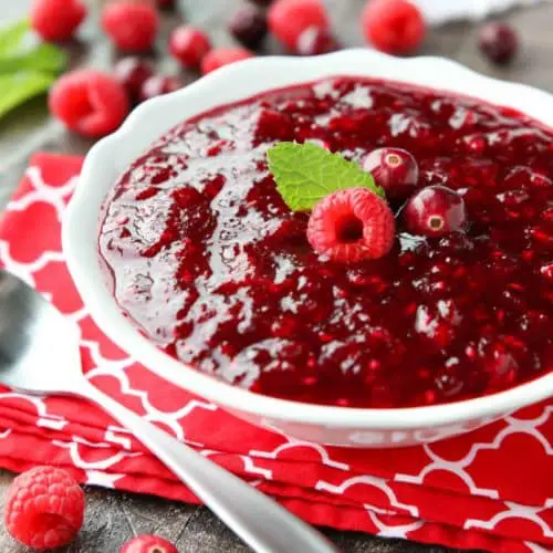 This easy raspberry cranberry sauce is sweet, tangy, and quick (only 4 ingredients & 15 minutes) to make! Uses fresh or frozen fruit, and is easy to make ahead of time. A classic for Thanksgiving or Christmas dinner.