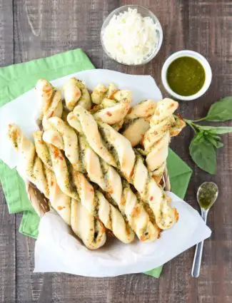 These easy Pesto Breadsticks are soft and flavorful with savory basil pesto and cheesy mozzarella twisted inside. A great appetizer or side for soup, salad, or pasta.﻿