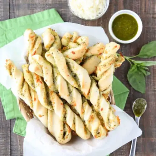 These easy Pesto Breadsticks are soft and flavorful with savory basil pesto and cheesy mozzarella twisted inside. A great appetizer or side for soup, salad, or pasta.﻿