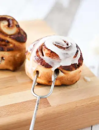 Campfire Cinnamon Rolls are cooked on a stick over a fire or grill. As easy as a can of biscuits, but with real yeast dough instead! The best cinnamon rolls you will ever have while camping!