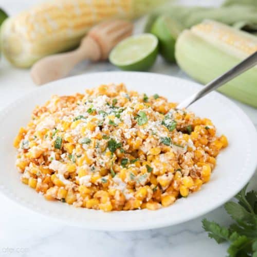 Mexican Street Corn Salad is easy, creamy, and packed with flavor! Your favorite roasted Mexican street corn (Elote) is cut off the cob (to make Esquites) and is served with a spoon, for a delicious summer side dish!