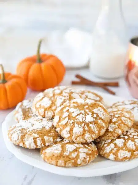 Pumpkin Crinkle Cookies are light, soft, and cake-like with warm, flavorful pumpkin spices. You'll love this easy fall cookie coated in powdered sugar that cracks as it bakes.