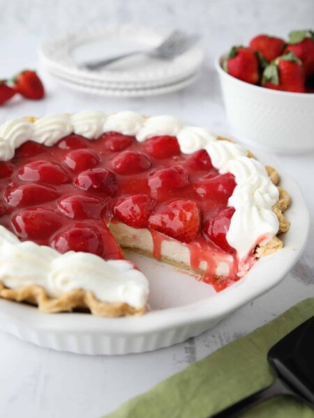 Strawberry Cream Pie is light, fruity, and delicious. With layers of pie crust, no-bake cheesecake, and slices of fresh strawberries smothered in a sweet glaze.