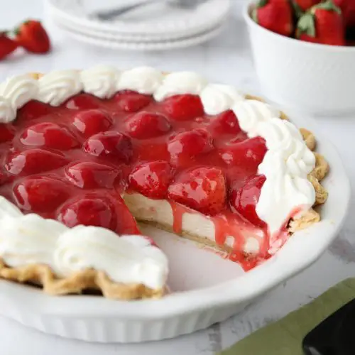 Strawberry Cream Pie is light, fruity, and delicious. With layers of pie crust, no-bake cheesecake, and slices of fresh strawberries smothered in a sweet glaze.