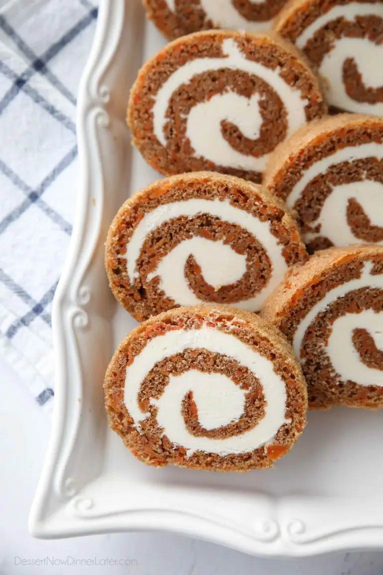 This Carrot Cake Roll is a classic Easter dessert with a twist. Spiced carrot cake is rolled up with the best cream cheese frosting inside. It's beautiful, delicious, and easy to make.