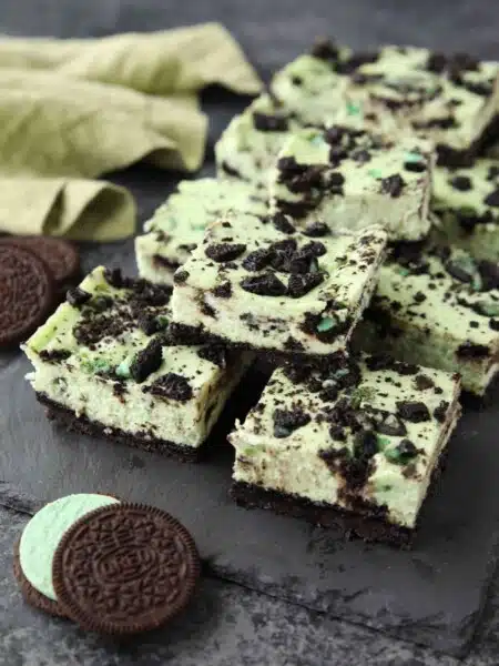 Mint Oreo Cheesecake Bars - a dessert for the mint chocolate lovers. With a mint Oreo crust, and a cool and creamy mint cheesecake loaded with extra chunks of mint Oreos throughout.