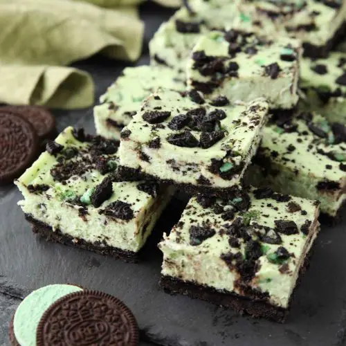 Mint Oreo Cheesecake Bars - a dessert for the mint chocolate lovers. With a mint Oreo crust, and a cool and creamy mint cheesecake loaded with extra chunks of mint Oreos throughout.