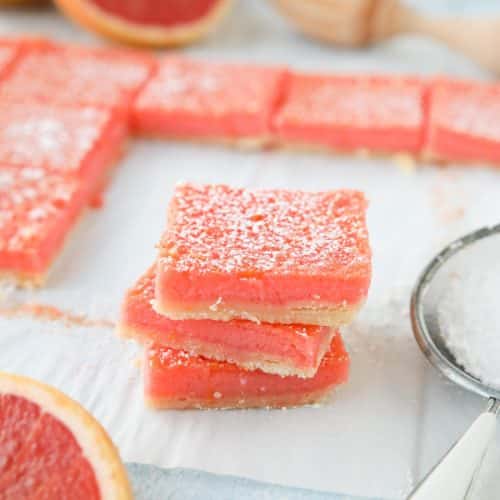 Grapefruit Bars are just like your favorite lemon bars with a shortbread crust and citrus curd, but with the sweeter flavor of pink grapefruit.