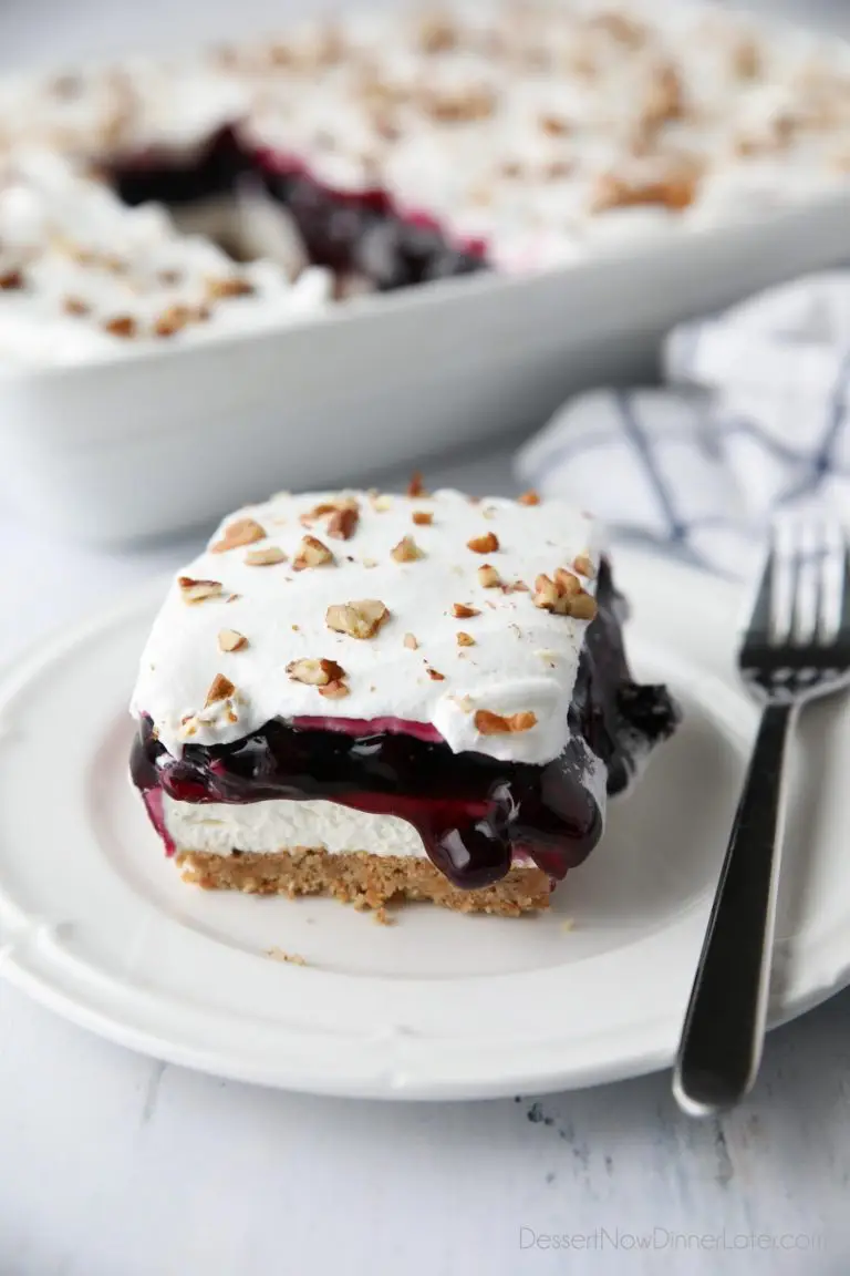 Blueberry Delight (aka Blueberry Lush) is an easy layered dessert with a graham cracker and pecan crust, no bake cheesecake, blueberry pie filling, and cool whip topping. A light, fruity, and delicious summer dessert with minimal baking.