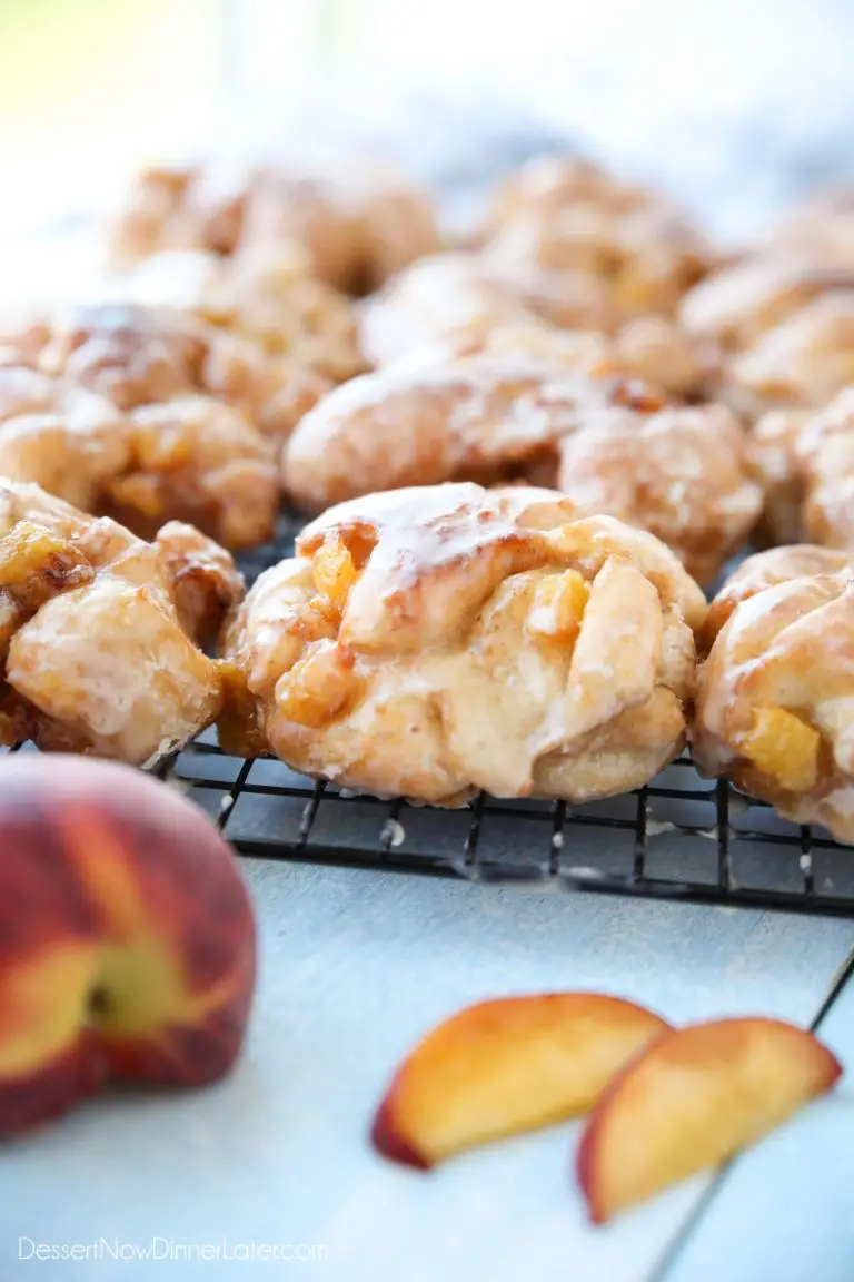 Glazed Peach Fritters Donuts on a cooling rack.