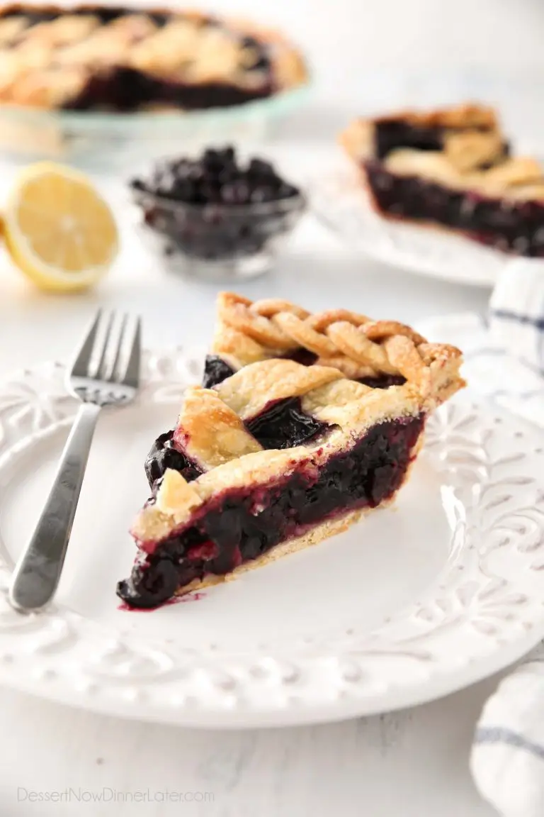 Slice of homemade blueberry pie made with frozen blueberries and simple ingredients to create a thick (not runny) pie filling from scratch.