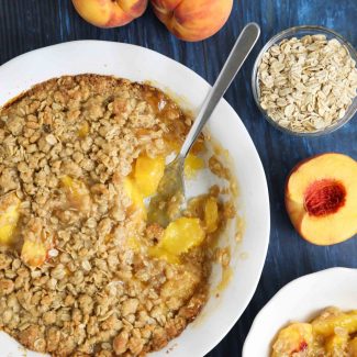 Fresh peach crisp made with a buttery brown sugar and cinnamon oat topping.
