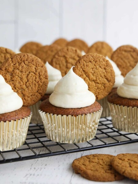 Gingerbread cupcakes with cream cheese frosting and a gingersnap cookies on top.