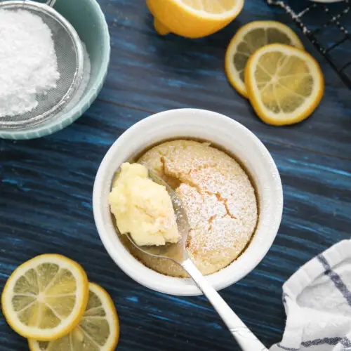 Spoonful of lemon pudding cake in ramekin.