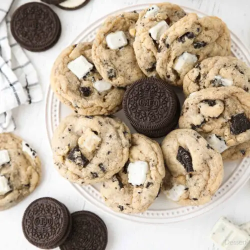 Plate of cookies and cream cookies with a stack of Oreos in the middle.