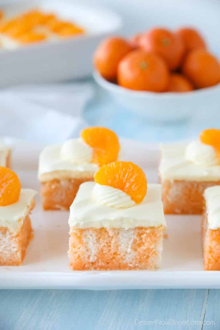 Close up of a slice of orange poke cake.