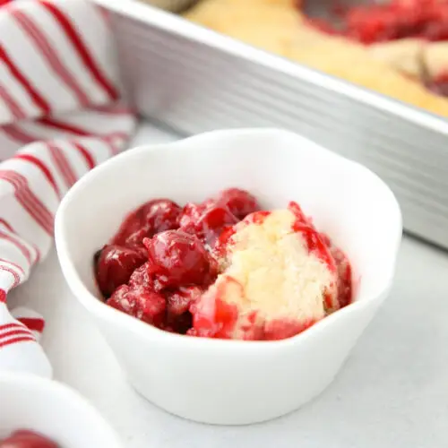 Cherry Cobbler in a bowl made from cherry pie filling and homemade cake batter.