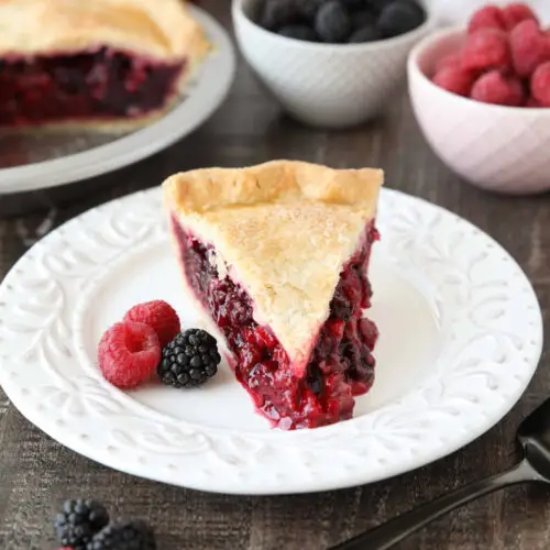 Slice of Razzleberry Pie on a plate. Focusing on the berry pie filling.