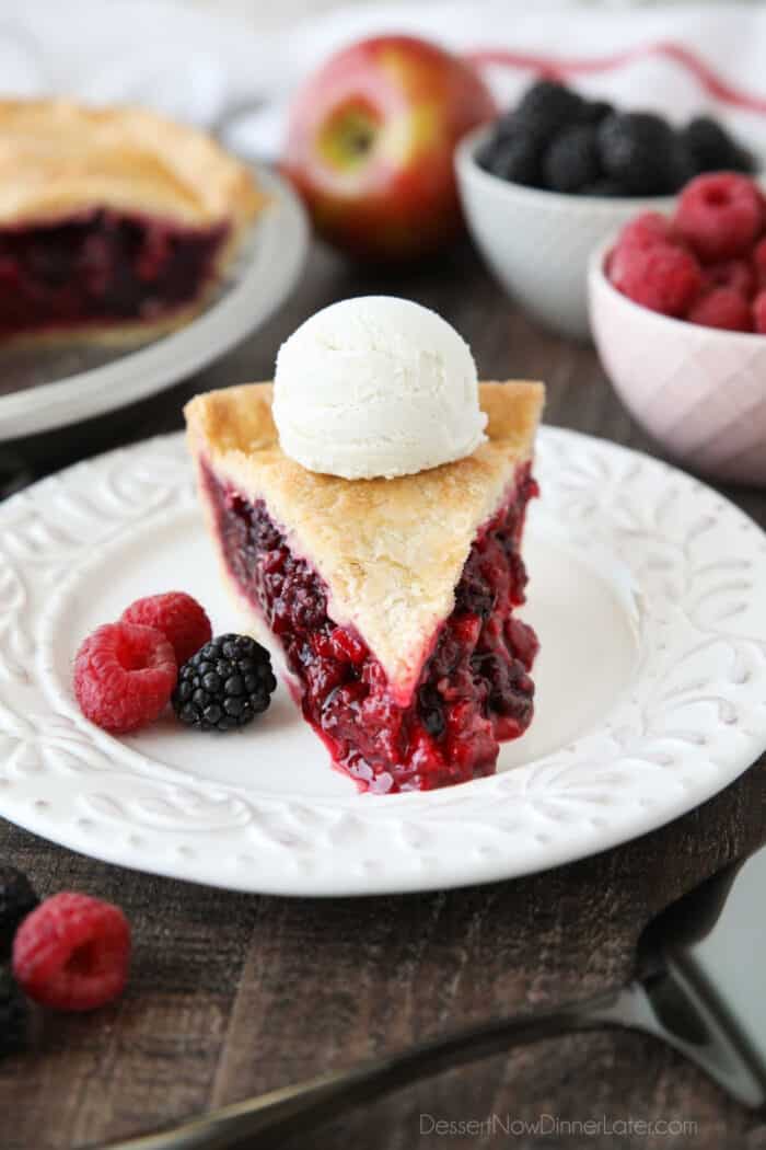 Slice of Razzleberry Pie with a scoop of vanilla ice cream on top.