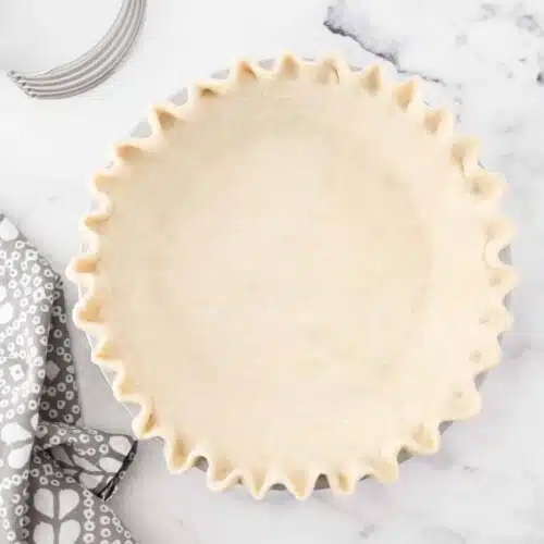 All butter pie crust fitted in pan with crimped edges.