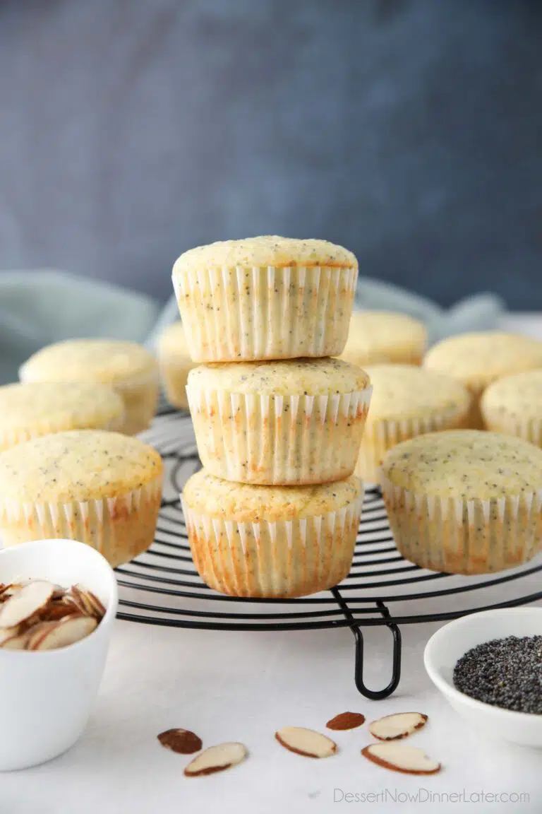 Almond Poppy Seed Muffins stacked on top of each other.