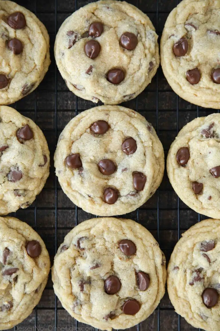 Baked chocolate chip cookies on wire cooling rack.