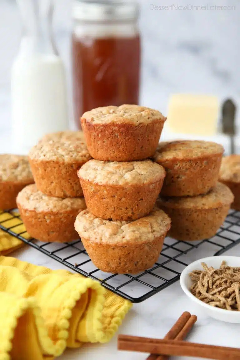 All Bran Muffins stacked on a wire cooling rack.