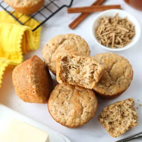 Muffins made with All-Bran cereal, with one muffin showing the light and fluffy interior texture.