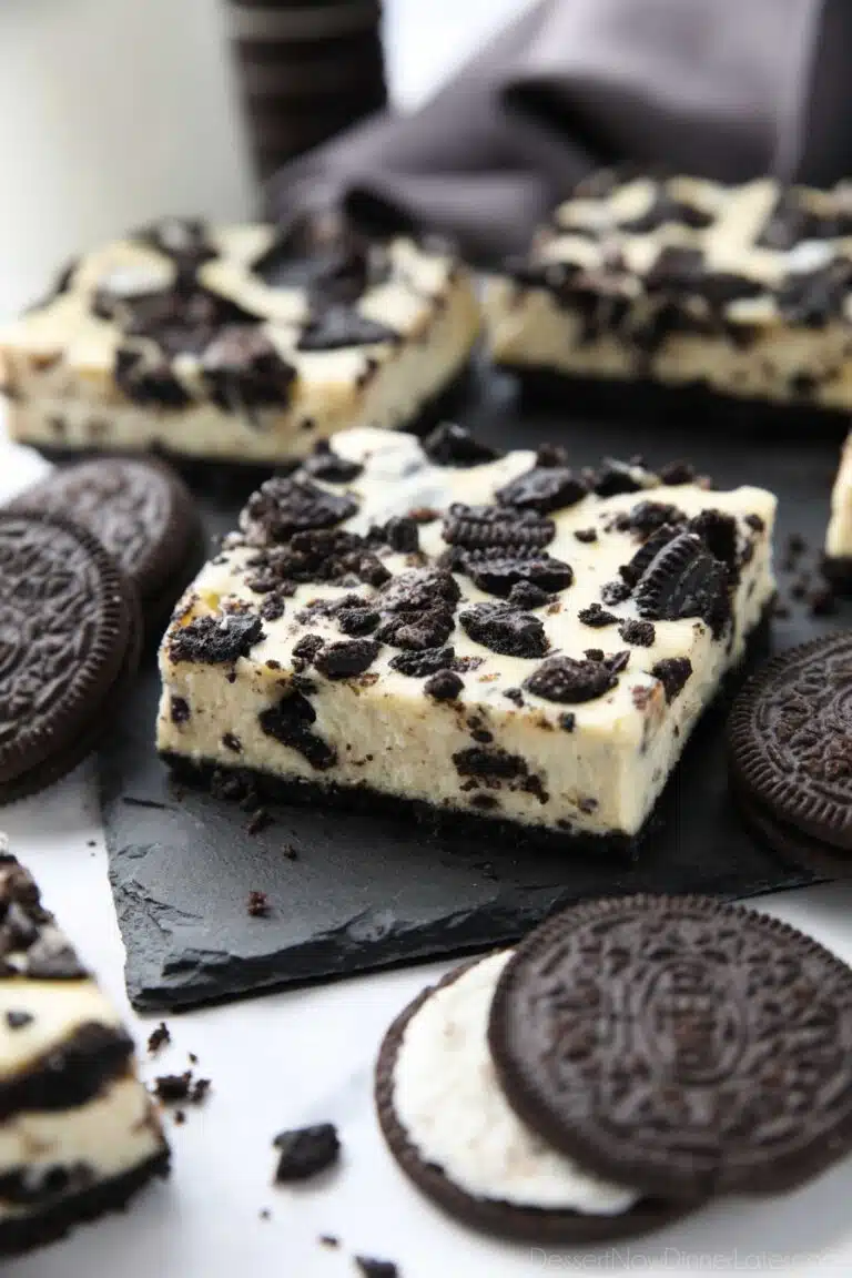 Close up of Oreo cheesecake bars with more Oreos.