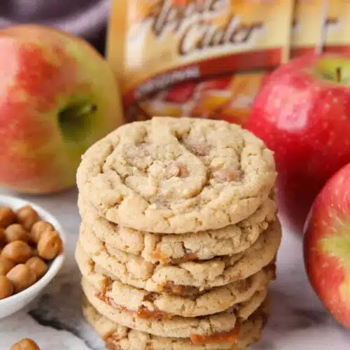 Stack of caramel apple cider cookies made with apple cider mix and caramel bits.