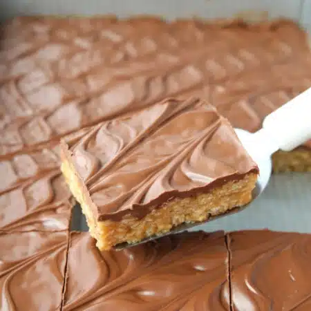 Scooping no bake scotcharoos (aka peanut butter rice krispie treats) out of the pan.