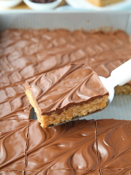 Scooping no bake scotcharoos (aka peanut butter rice krispie treats) out of the pan.