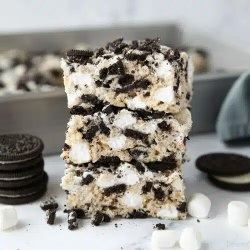 Stack of Oreo rice krispie treats with extra marshmallows and chunks of Oreo cookies.