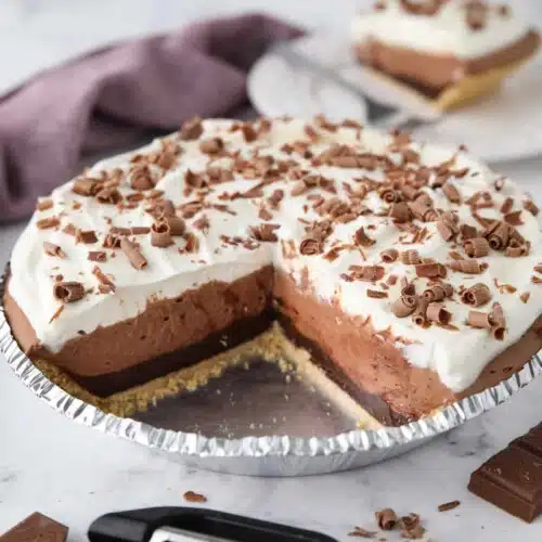 Chocolate Truffle Pie in pan with pieces taken out to show filling.