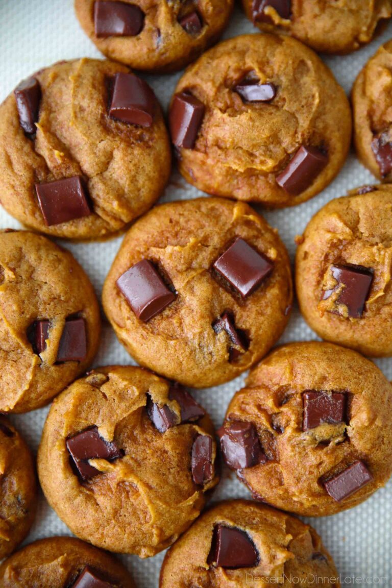 Closeup of pumpkin chocolate chunk cookies on a silicone baking mat.