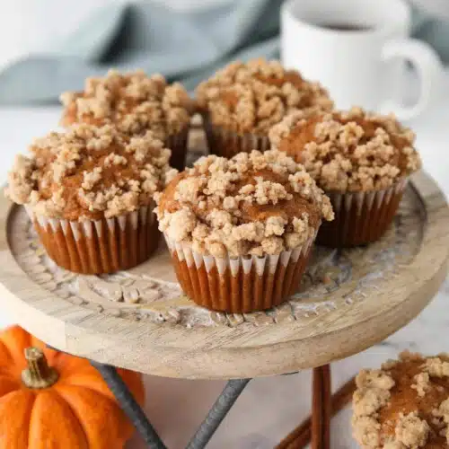 Pumpkin streusel muffins on a cake stand.