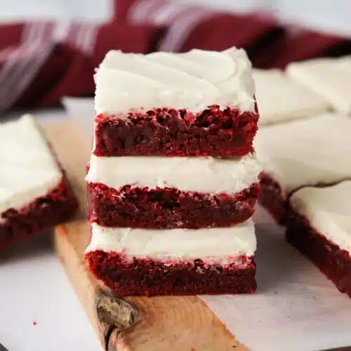 Stack of three Red Velvet Brownies with cream cheese frosting.