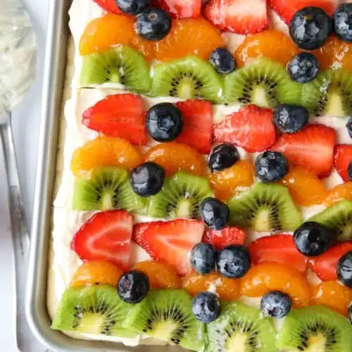 Top view of sugar cookie fruit pizza bars with cream cheese frosting.