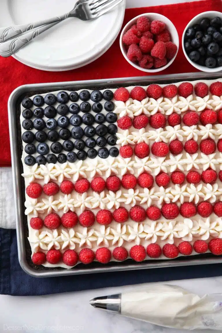 4th of July Fruit Pizza made with a brownie base and decorated with whipped cream cheese frosting, blueberries and raspberries for the stars and stripes.