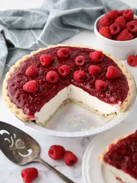 Slices removed from pie pan to show the inside of Raspberry Cream Cheese Pie.