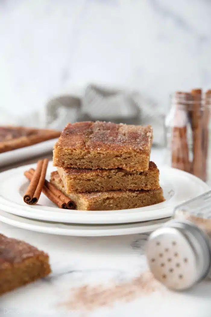 Side view of a stack of cinnamon bars on a plate.