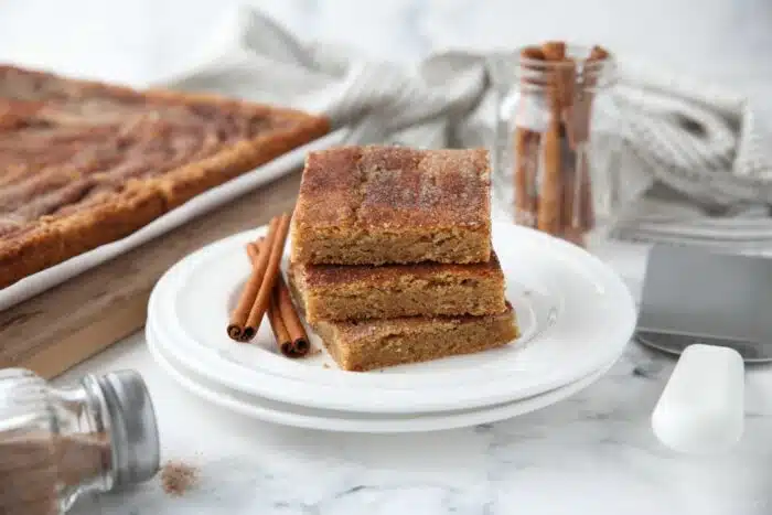 Front view of a stack of cinnamon bars on a plate.