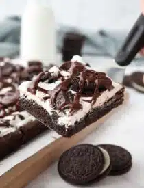 Scooping up a cookies and cream brownie with a spatula.