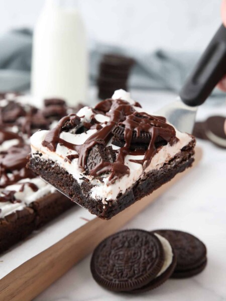 Scooping up a cookies and cream brownie with a spatula.