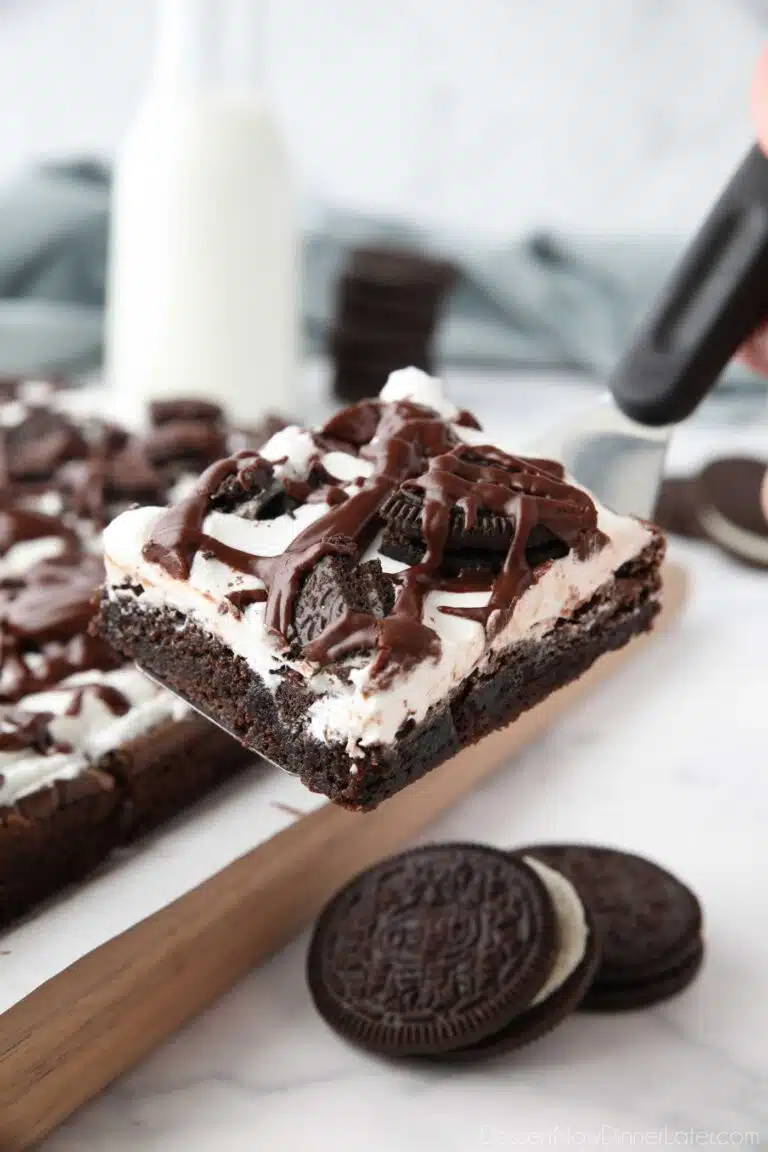 Scooping up a cookies and cream brownie with a spatula.