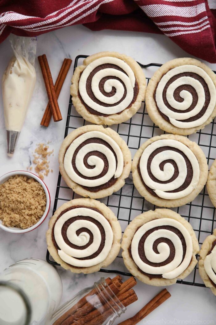 Top view of Cinnamon Roll Sugar Cookies with swirled frosting on a wire cooling rack.