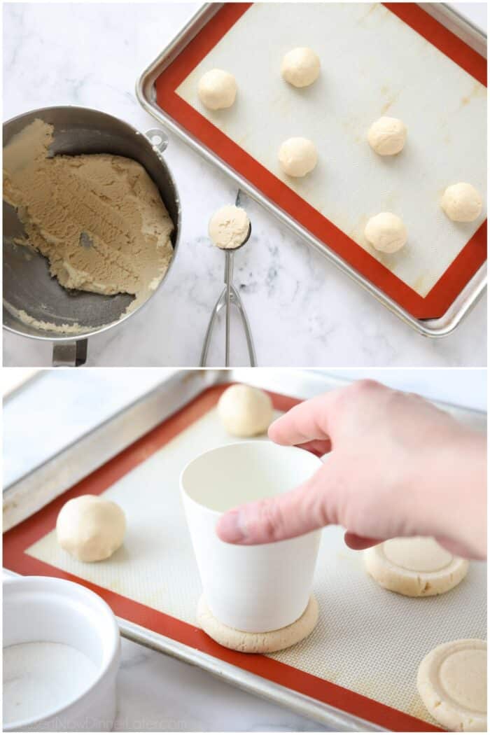 Sugar cookie dough scooped and rolled into balls on a tray, then flattened with the bottom of a cup.